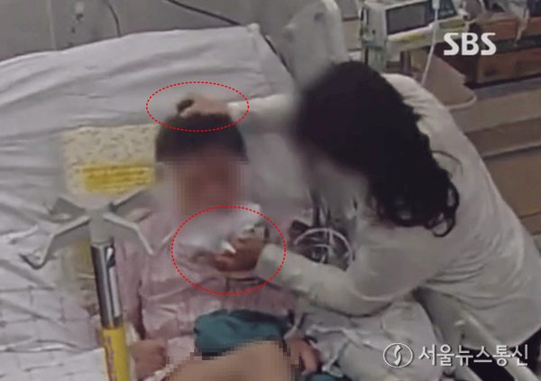 지난달 서울 광진구의 한 대학병원 1인실에서 60대 뇌염 환자를 간병인이 폭행하는 장면이 CCTV에 포착됐다고 지난 16일 SBS가 보도했다. (2024.01.07) / 사진 = SBS 갈무리 