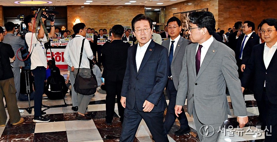 더불어민주당 이재명 대표 등 의원들이 19일 서울 여의도 국회에서 열린 제418회 국회(정기회) 제8차 본회의에 참석하고 있다. 이들 뒤로 국민의힘 의원들이 입법 폭주 및 포퓰리즘 규탄 등의 피켓을 들고 구호를 외치고 있다. (2024.09.19) / 사진 = 서울뉴스통신 신현성 기자