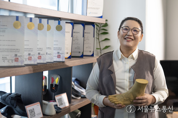 김남희 페도라인 보행센터 대표가 사람 발 모형을 들고 기념사진을 찍고 있다. (사진제공 페도라인 보행센터) 2025.07.11, snakorea.rc@gmail.com , *재판매 및 DB 금지