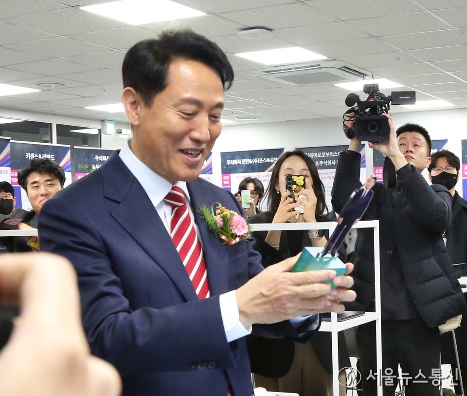 오세훈 서울시장이 25일 오후 서울 서초구  AI허브 메인센터에서 열린 AX 혁신센터 출범식에 앞서 AX 스타트업 전시를 둘러보다 한 부스에서 전신 모형을 선물받고 있다. 2025.11.25, snakorea.rc@gmail.com , *재판매 및 DB 금지